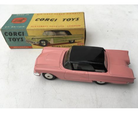 A boxed Corgi Toys Ford Thunderbird No 214 M in pink and black with mechanical works...some damage to box