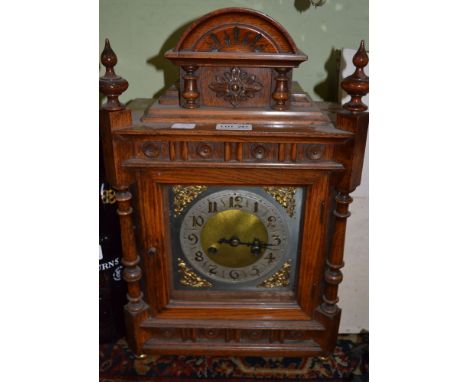 A 19th century light oak ornate mantle clock