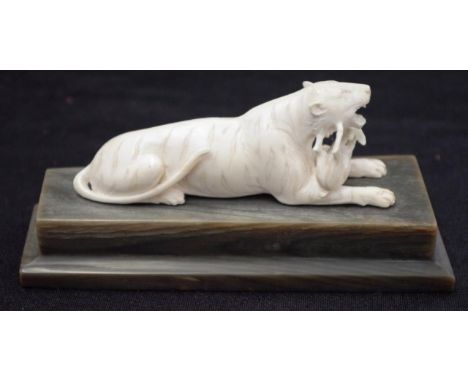 Vintage carved ivory tiger with its prey mounted on a horn base, length of tiger 10cm approx., this item cannot be exported