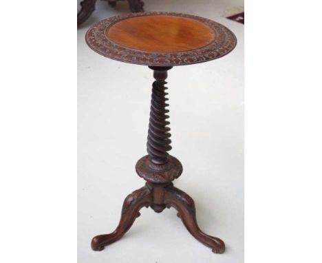 Antique Anglo Indian mahogany wine table with carved round top supported by a corkscrew spiral pedestal and carved tripod bas