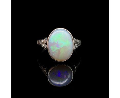 Antique opal and white gold ring solid white opal with flashes of blue and greens, with hand made ivy and scroll work shoulde