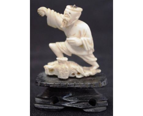 Chinese carved ivory fisherman figure standing fisherman, on carved wood stand, (small losses), (height 6cm approx). NOTE: Ex