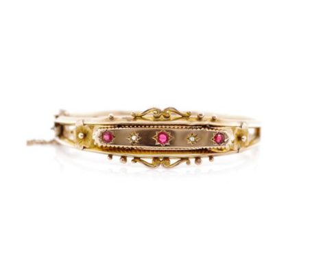 Edwardian 9ct rose gold bangle set with red gemstones and rough cut diamonds. Marked Birmingham 1905 JHW to applied setting. 