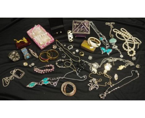 Collection of vintage costume jewellery including necklaces, brooches, and bangles
