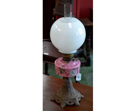 A Victorian oil lamp, with finely detailed cast iron base