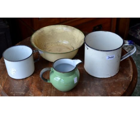 A vintage enamel bowl; two enamel mugs; an enamel jug (4)