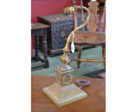 A heavy brass adjustable desk lamp