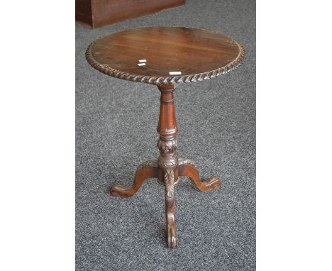 A reproduction mahogany tilt top tripod table, circular top, gadrooned border, turned column, cabriole legs, acanthus carved 