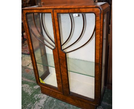 An Art Deco walnut china display cabinet.