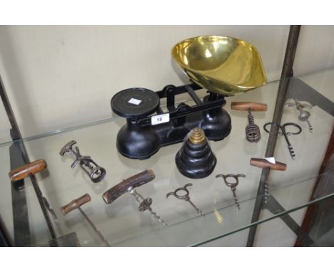 Kitchenalia - an assortment of corkscrews; a set of balance scales with graduated brass weights; a large terracotta pancheon 