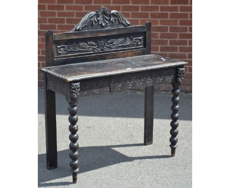 A Gothic revival oak hall table, carved gallery, rectangular top, demi-lune border, single drawer to frieze, bobbin turned fo