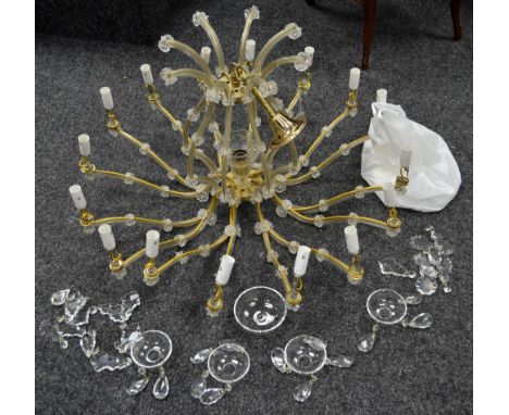 A modern sixteen light chandelier, S-form scrolling arms, faceted droppers.