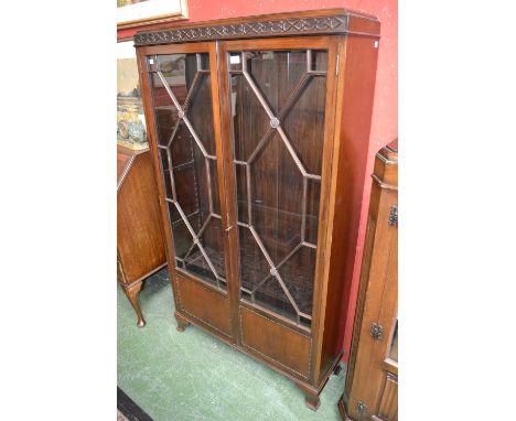 An early 20th century mahogany bookcase cabinet, astragal glazed doors, bracket feet