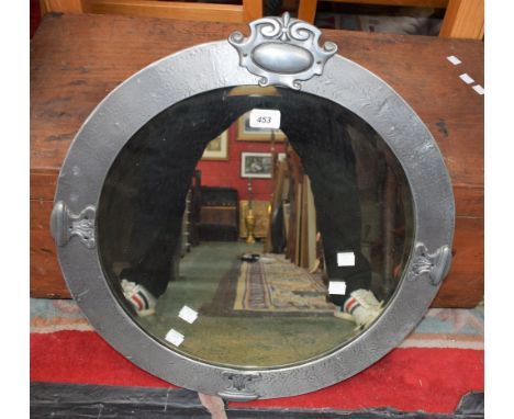A circular Art Nouveau style wall mirror