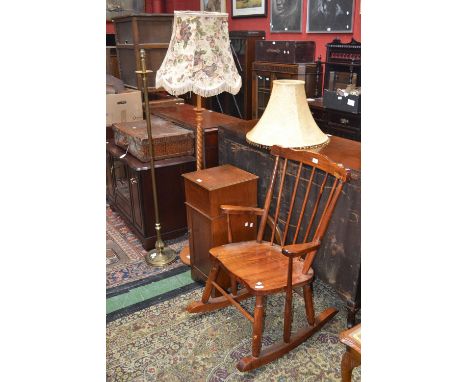 A barley twist standard lamp; a metalwork standard lamp; an oak pot cupboard; an oak oval mirror and a spindle back rocking c