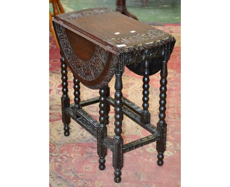 A small oak dropleaf occasional table, carved border, bobbin turned supports.