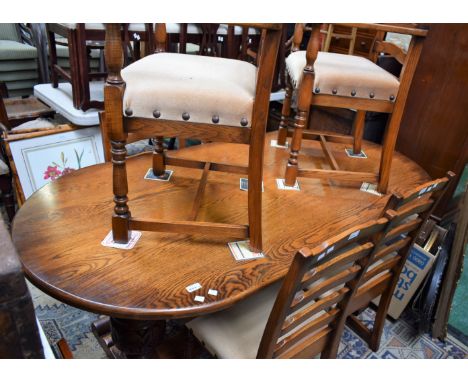 An oak dining table and six ladder back chairs