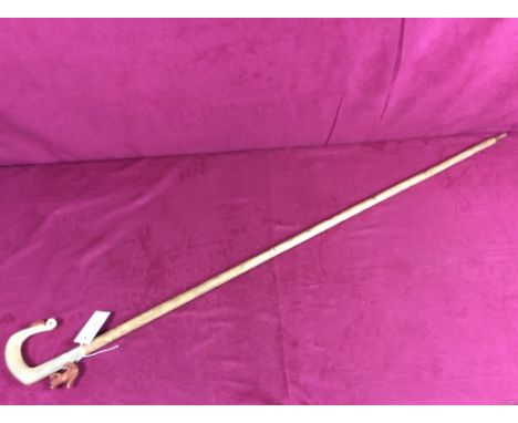 A walking stick, the carved handle decorated with squirrel and nut