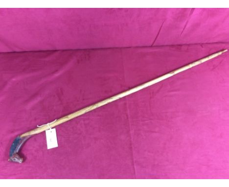 A walking stick, the handle decorated with a horses head