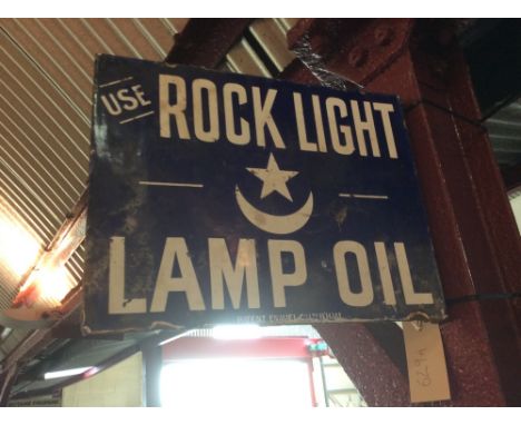 A vintage double sided enamel advertising sign for "Rock Light Lamp Oil"