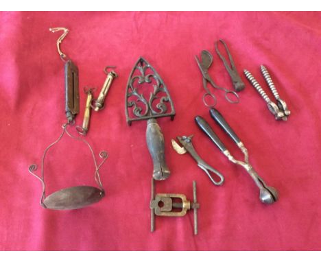 A box of various Bygones to include a hearth stand; a spring balance; a vintage can opener etc.