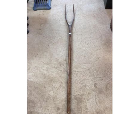 A rustic wooden hay fork