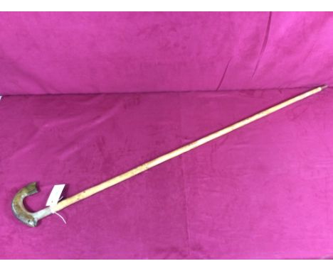 A walking stick, the handle decorated with a trout