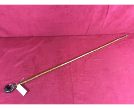 A walking stick, the carved handle decorated with a dogs head