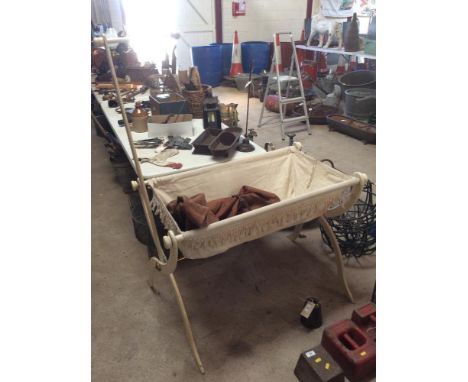 A vintage travel cot and a carrying bag