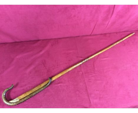 A walking stick, the handle carved with a snake