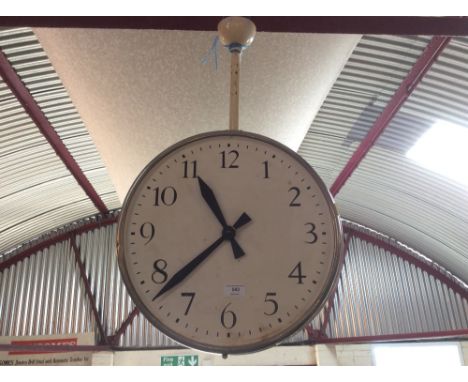 A large hanging double sided clock