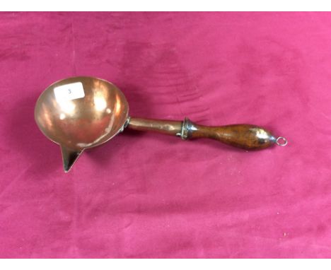 A mid 19th Century copper side pouring ladle with turned wooden handle 