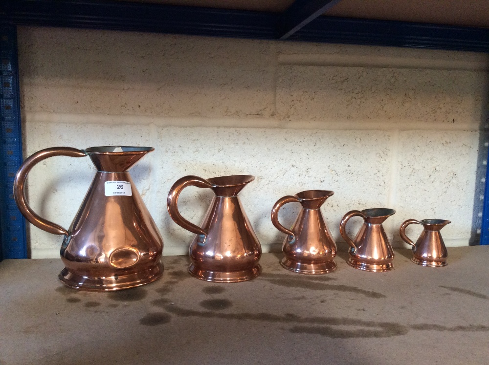 A set of six antique graduated copper jugs