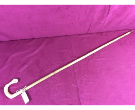 A walking stick, the handle decorated with a swan