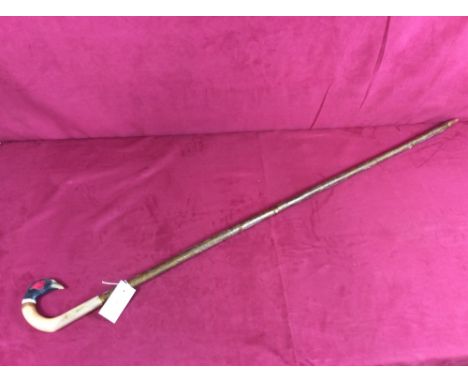 A walking stick with carved pheasant handle