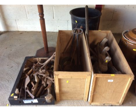 A collection of interesting old tools and metalware to include a brass long handled measure, various fire irons, grappling ir
