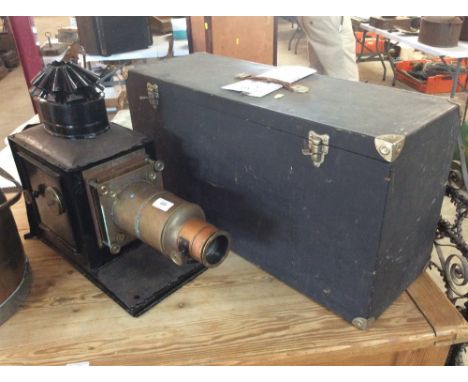 An antique brass and painted metal Magic Lantern projector in fitted wooden box