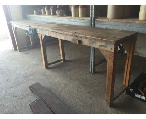 A large wooden work bench with vice 320cm long