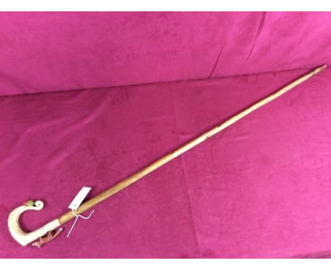 A walking stick, the horn handle decorated with a fox and thistle
