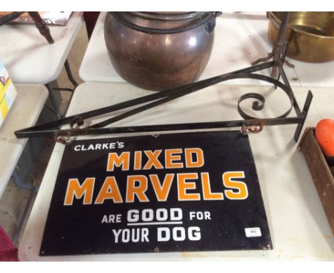 An enamel advertising sign for "Clarke's Mixed Marvels Are Good For Your Dog" hung to an iron bracket