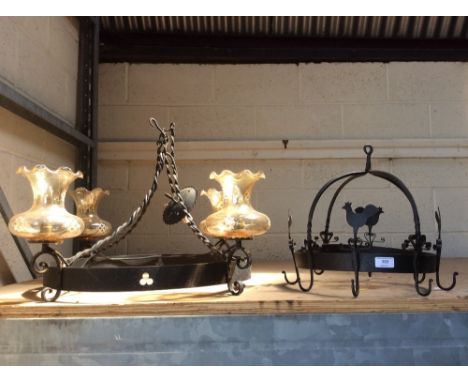 A wrought metal rustic design pot hanger; and a wrought metal four branch ceiling light