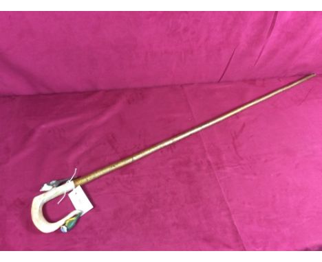 A walking stick with carved bird decoration to the horn handle