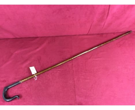 A walking stick with ebonised handle