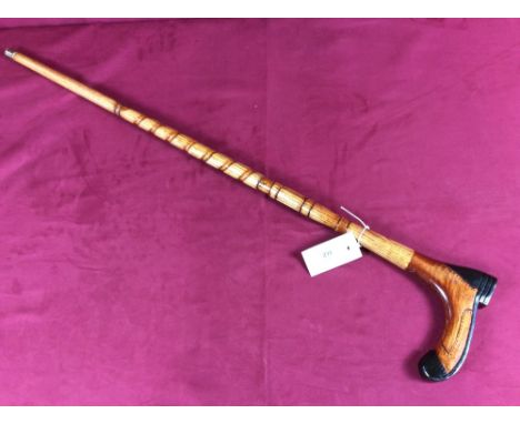 A carved walking stick with boot handle, initialed S.H. and dated 1992