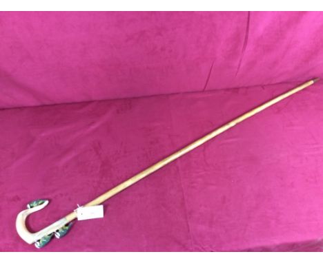 A walking stick with carved horn handle decorated woodpeckers