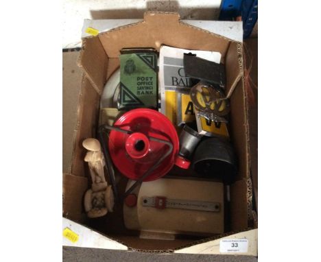 A box containing various vintage items including AA car badges, a bell, enamel chamber stick, a mirror etc.