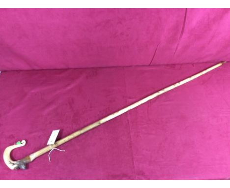 A walking stick, the horn handle decorated with a stag and thistle