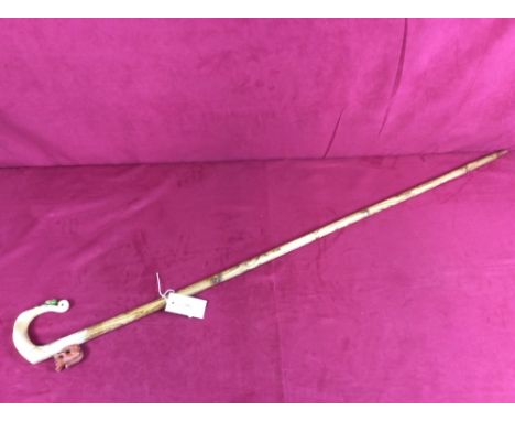 A walking stick, the horn handle carved with squirrel and acorn