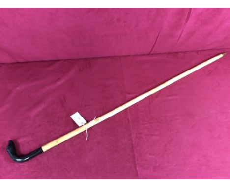 A walking stick, the ebonised handle decorated with a dogs head