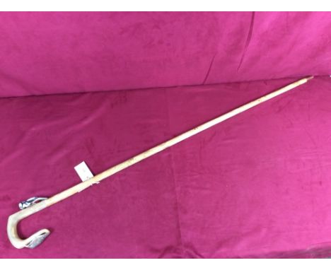 A walking stick, the horn handle decorated with woodpeckers